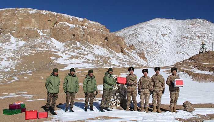 Indian and Chinese army greet each other along the Line of Actual Control (LAC) near Karakoram pass in Ladakh on October 31, 2024, on the occasion of Diwali. — AFP