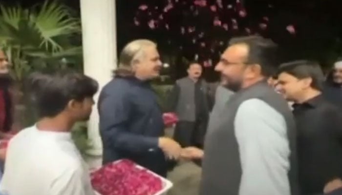 KP CM Ali Amin Gandapur shower flowers petals on a rescue personnel. — Screengrab via YouTube/Geo News