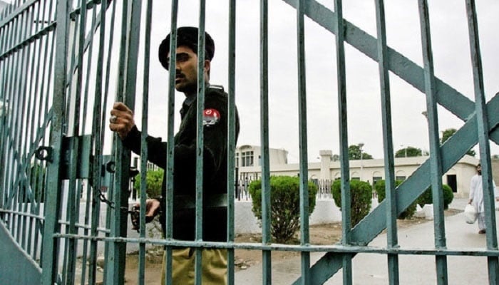 Police official closes the main gate of Adiala Jail, Rawalpindi in this undated photo. — AFP/File