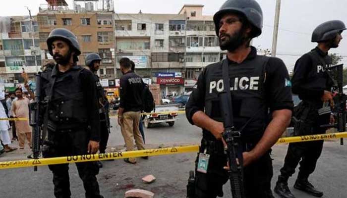 A file photo of police officers guarding a site following an attack in Karachi. — Reuters