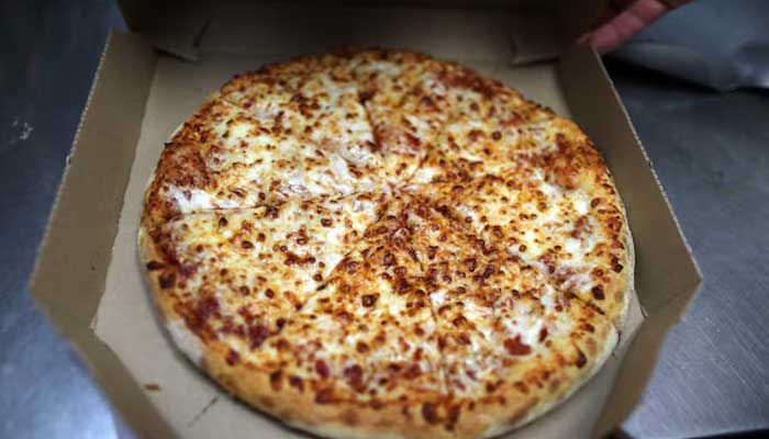 A pizza comes out of the oven at local restaurant in Los Angeles, California, US July 18, 2018. — Reuters