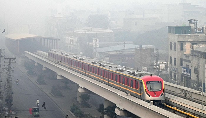 An Orange Line Metro Train (OLMT) is pictured on an elevated track amid smoggy conditions in Lahore on on November 3, 2024. — AFP