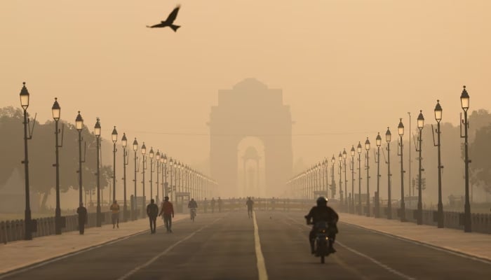 People walk on Kartavyapath near India Gate on a hazy morning in New Delhi, India, November 1, 2024. —Reuters