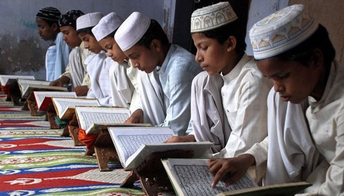 Students recite the Holy Quran at an Islamic school in India. — Reuters/File