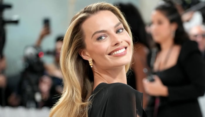 Margot Robbie goes for a stroll with newborn baby and husband Tom Ackerley