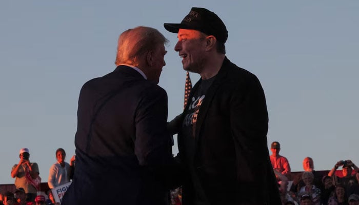 Tesla CEO and X owner Elon Musk stands with Republican presidential nominee former US president Donald Trump during a campaign rally, on the day Trump returns to the site of the July assassination attempt against him, in Butler, Pennsylvania, US, on October 5, 2024. — Reuters