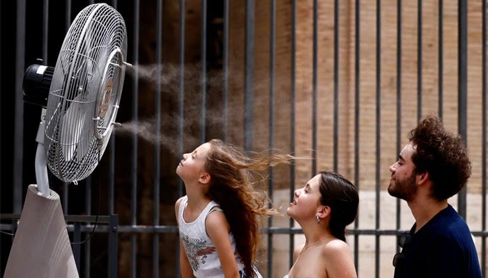 An undated image shows people standing in front of a cooler installed around the Colosseum amid a heatwave in Rome, Italy. — Reuters