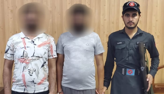 Two of the suspects arrested by FIA during raids standing with a security official on November 7, 2024. —Reporter