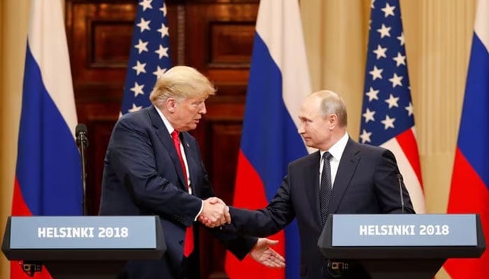 US President Donald Trump and Russian President Vladimir Putin shake hands as they hold a joint news conference after their meeting in Helsinki, Finland on July 16, 2018. — Reuters