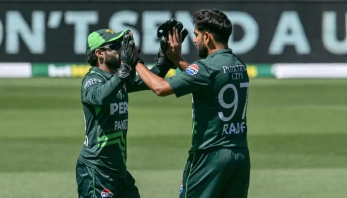 Haris Rauf (right) celebrates with teammate Mohammad Rizwan during the ODI against Australia. —AFP