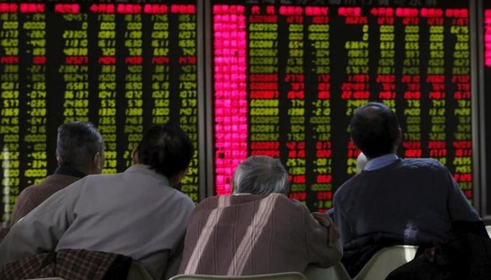 Brokers at the PSX look at the electronic board in this undated image. — Reuters