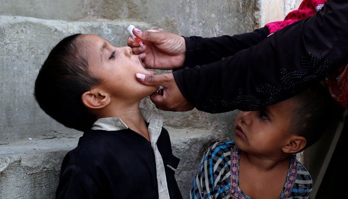 A boy receives polio vaccine drops, during an anti-polio campaign, in a low-income neighbourhood in Karachi, April 9, 2018. — Reuters