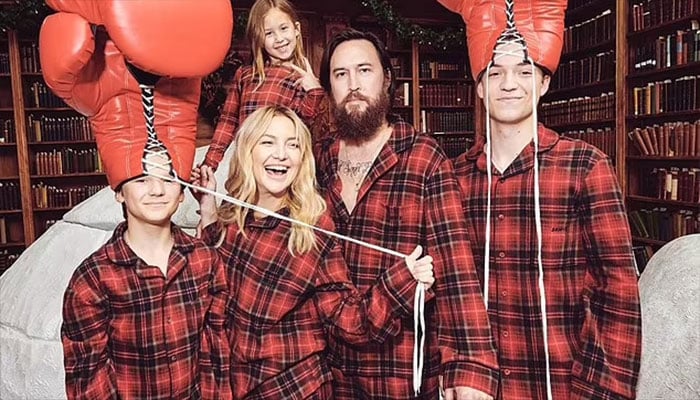 Kate Hudson and Goldie Hawn share sweet holiday moments in matching pajamas.