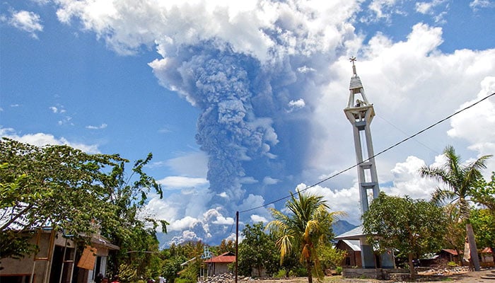 Schoolchildren run during the eruption of Mount Lewotobi Laki-Laki, as seen from Lewolaga village in East Flores, East Nusa Tenggara on November 7, 2024. — AFP