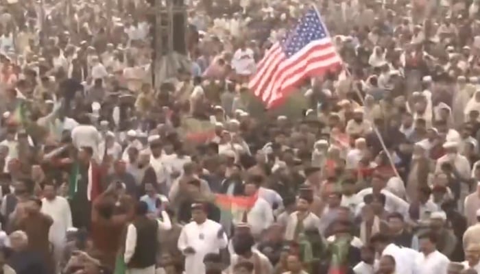 A PTI workers waives US flag at the partys rally in Swabi, on November 9, 2024. — Screengrab/Geo News