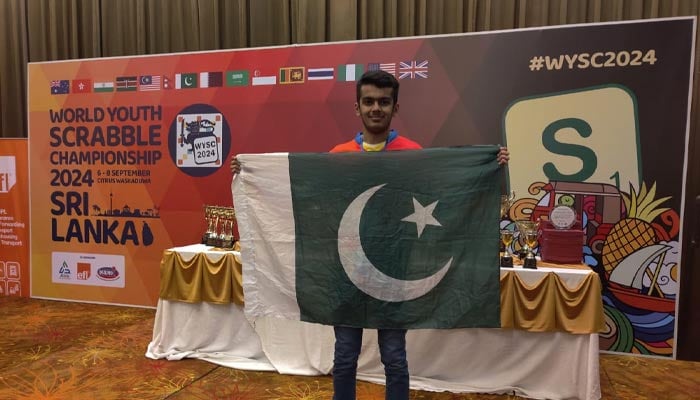 Affan Salman holding up Pakistani flag while celebrating his victory in the World Youth Scrabble Championship 2024. — Geo Super/File