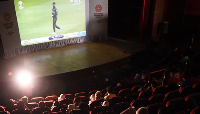 Pakistani people watch a live broadcast of the match between in a theatre in Karachi. ─ AFP/File