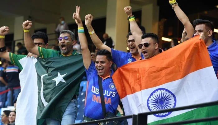 A representational image showing Pakistani and Indian cricket fans holding their national flags during a match. — AFP/File