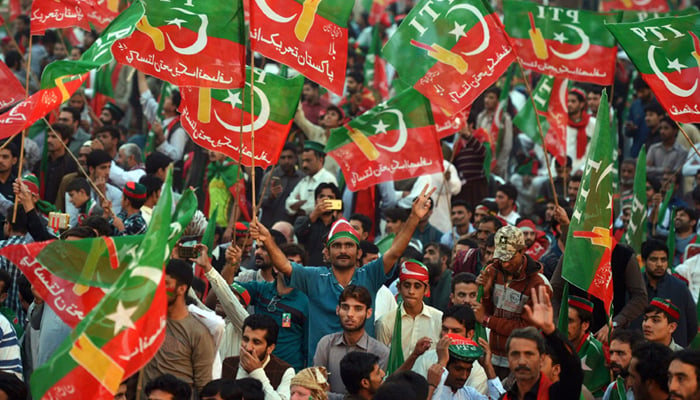 PTI supporters waive flags during a protest in this undated image. — Reuters