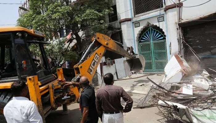 A bulldozer demolishes a part of a mosque in Jahangirpuri, New Delhi. — Reuters