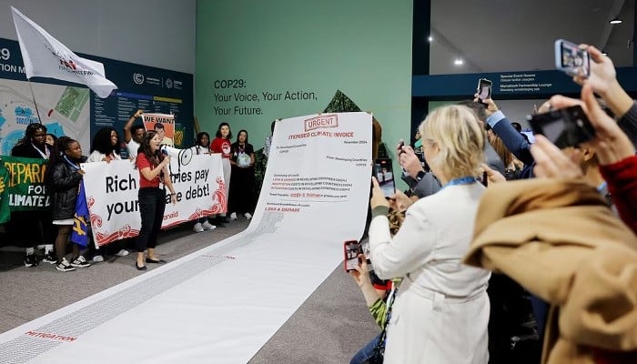 Activists display a 10m long climate invoice directed at developed countries at a protest during the United Nations COP29, in Baku, Azerbaijan November 14, 2024. — Reuters