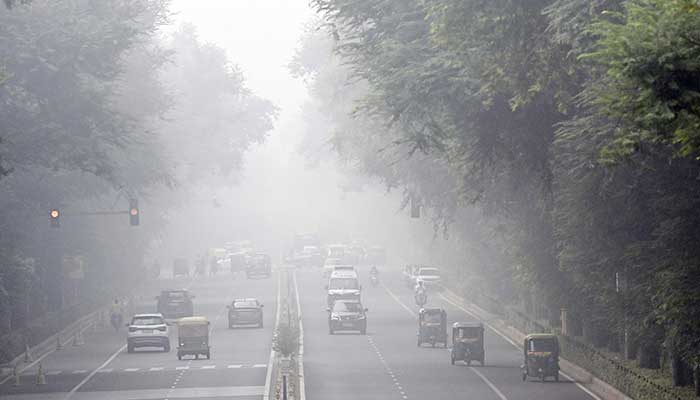 Commuters drive amid dense smog in New Delhi on November 13, 2024. — AFP