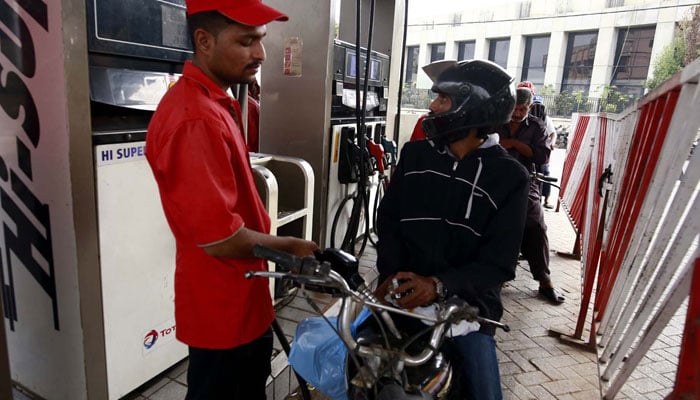 A worker filling petrol in a motorbike at Fuel Station in Karachi, September 1, 2023. — PPI