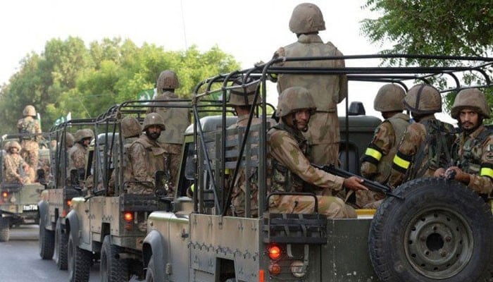 Army personnel can be seen sitting in a military vehicle. — AFP/File