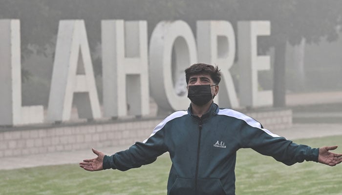 A man exercises in a park amid heavy smoggy conditions in Lahore on November 7, 2024. — AFP