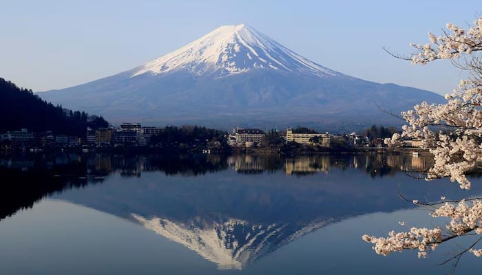 A general view of cherry blossom trees with Mount Fuji in the background at Lake Kawaguchiko, Fujikawaguchiko, Japan, April 14, 2024. — Reuters