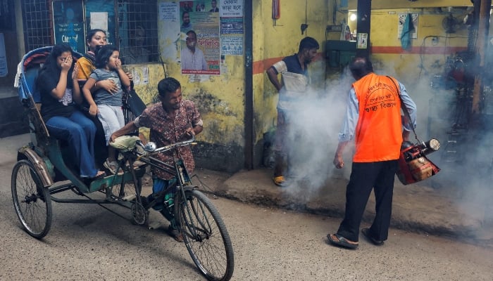 A city corporation worker sprays fumigator to control mosquitoes in Dhaka, Bangladesh, on October 14, 2024. — Reuters