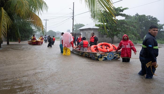 Rescue teams help people to get out of their houses in a flooded area as tropical storm Sara hits, in Monte Fresco, Honduras, November 15, 2024. — Reuters