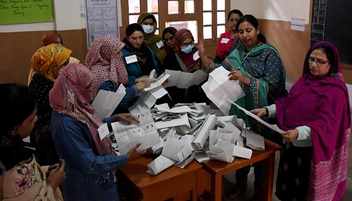 Polling staff count ballots after the end of the voting at a polling station during a general election, in Hyderabad on February 8, 2024. — Reuters