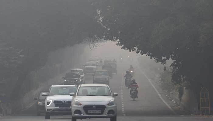 Traffic passes by on a road as the sky is enveloped with smog after Delhis air quality was classified as hazardous amidst severe air pollution, in New Delhi, India on November 14, 2024. — Reuters