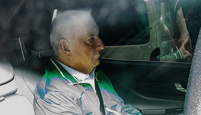 Alan Jones is seen in the back of an unmarked police car as he is transferred to Day St Police Station, in Sydney, Australia, November 18, 2024. — Reuters