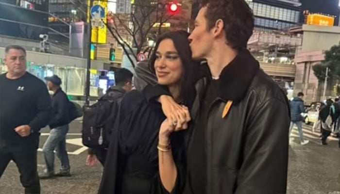 Dua Lipa and Callum Turner snuggle up in Tokyo.