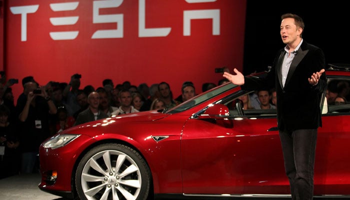 Tesla Motors CEO Elon Musk speaks next to the companys newest Model S during the Model S Beta Event held at the Tesla factory in Fremont, California October 1, 2011. — Reuters