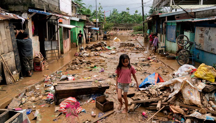 A girl walks past the debris and mud following the floods brought by Typhoon Gaemi, in Marikina City, Metro Manila, Philippines, July 25, 2024. — Reuters