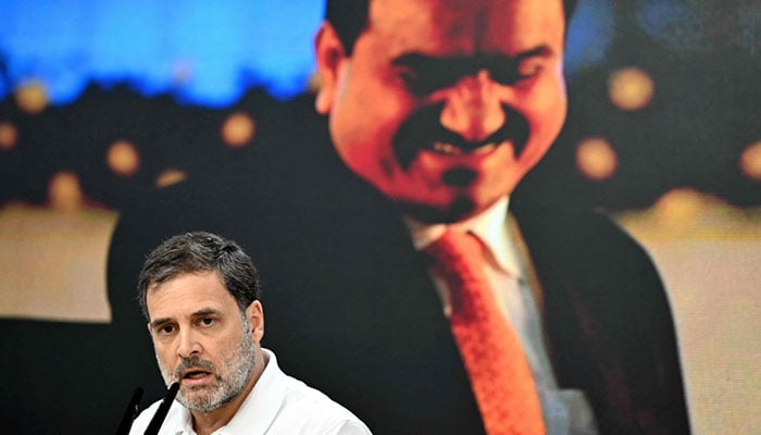 India´s Congress party leader Rahul Gandhi addresses a press conference against the backdrop of a picture of Indian industrialist Gautam Adani, at his party headquarters in New Delhi on November 21, 2024. — AFP