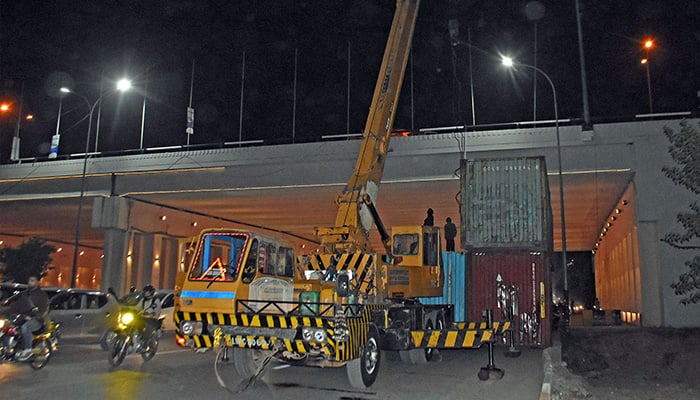 A view of heavy shipping containers arriving at Islamabad Highway for road block ahead of upcoming PTI protest in Islamabad — November 20, 2024. — Online