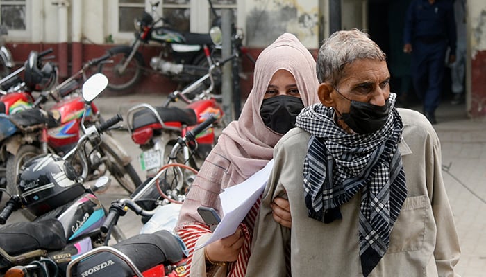 People wear masks to protect themselves against smog and air pollution while leaving a hospital in Lahore, Pakistan November 13, 2024. — Reuters