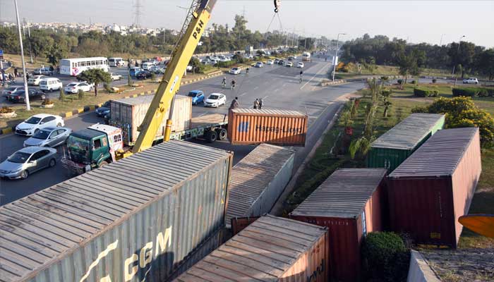 Authorities placed heavy shipping containers near the Faizabad flyover on the Islamabad Expressway to block the road ahead of the PTI protest in Islamabad on November 21, 2024. — Online