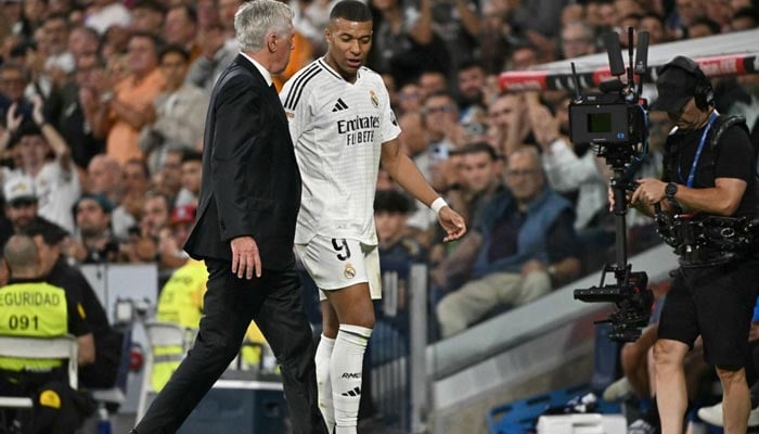 Real Madrids forward Kylian Mbappe talks with coach Carlo Ancelotti as he leaves the pitch during match between Real Madrid CF and Deportivo Alaves in Madrid on September 24, 2024. — AFP