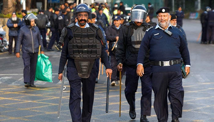 Police officers walk to guard a road to prevent an anti-government rally by supporters of PTI founder Imran Khan in Islamabad, November 24, 2024. — Reuters