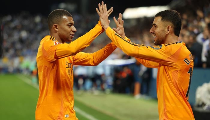 Real Madrids Kylian Mbappe (left) and Dani Ceballos celebrate after Federico Valverde scores their second goal during a LaLiga match against Leganes at the Estadio Municipal de Butarque, Leganes, Spain on November 24, 2024. — Reuters