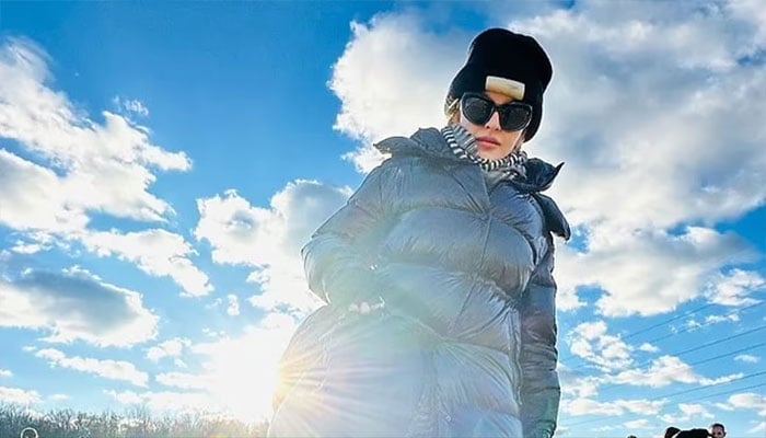 Madonna dazzles in huge sunglasses and fur hat.