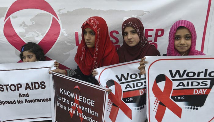 Pakistani social activists carry placards during a rally to raise awareness on World AIDS Day in Lahore on December 1, 2016. — AFP