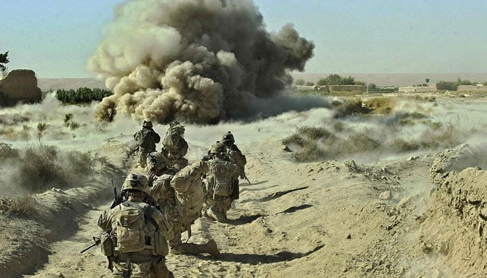 Dust kicks off the ground during an operation by US Army soldiers attached to the 2nd platoon Infantry based at Zangabad foward operating carry out a safe detonation of an IED on a road during an operation at Naja-bien village, in Afghanistan. — AFP/File