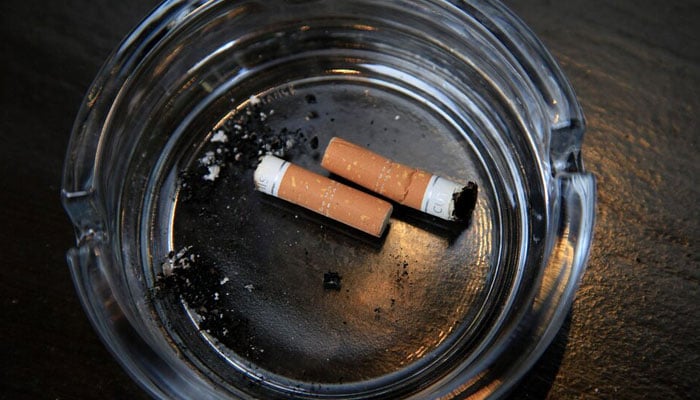 An ashtray with cigarette butts is seen outside a restaurant in London, March 9, 2011. — Reuters