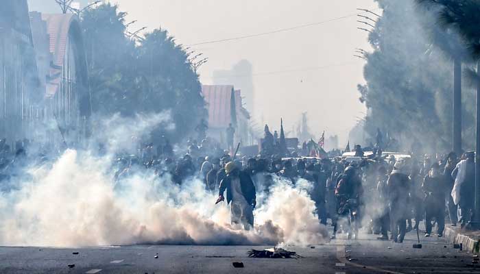 Policemen fire tear gas shells to disperse PTI supporters during a protest at the Red Zone area in Islamabad on November 26, 2024. — AFP